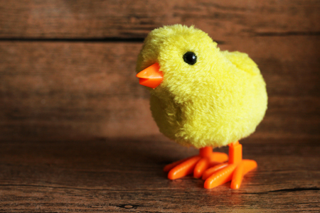Little decorative chicken on wooden background, toyの写真素材