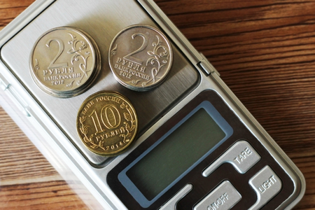 Coins on scale, electronic scales, measuring instrument moneyの写真素材