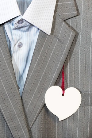 Business men's gray suit with a price tag in the form of a heart, ideaの写真素材