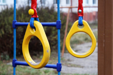 Traditional wooden gymnast rings hanging, outdoor, yellow color