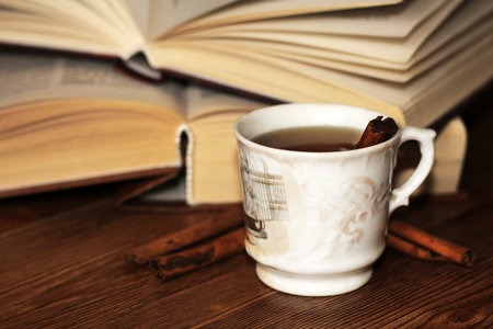 A Cup of coffee, cinnamon sticks and old books, drinkの写真素材