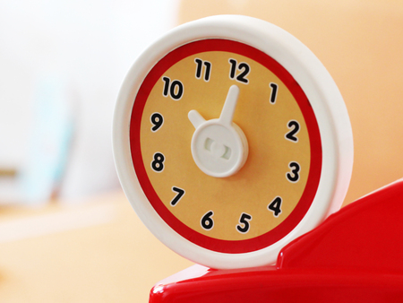 O'clock round toy clock, plastic object, red colorの写真素材