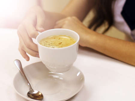 Female hands holding a cup of coffee, drinkの写真素材