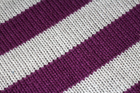 Folded in a row knitted things from natural yarn, close up