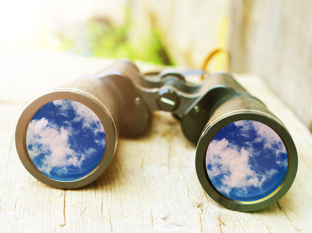 The reflection of the sky and clouds in the glass of the binoculars, ideaの写真素材