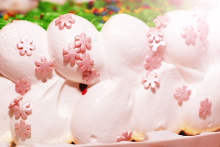 Pieces of homemade walnut carrot cake with icing cream on white plate. Selective focus. Close up.の写真素材