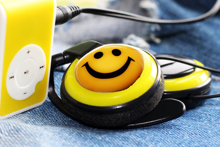 Yellow music player and beautiful overhead headphones, luxの写真素材