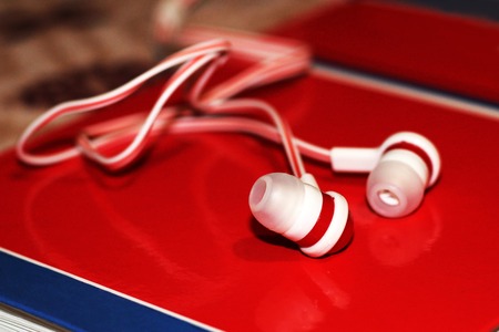 Close up on red earbuds, a trendy device for the player, soundの写真素材