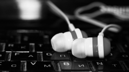 Close up on black and white earbuds, a trendy device for the player, soundの写真素材