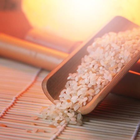 The rice on the small draining Board, Chinese design, beautiful orange light. Food.の写真素材