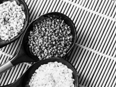 Dry white colored rice in wooden spoon, foodの写真素材