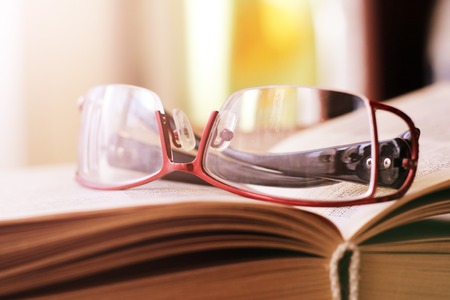 Women's beautiful glasses on the book, objectの写真素材