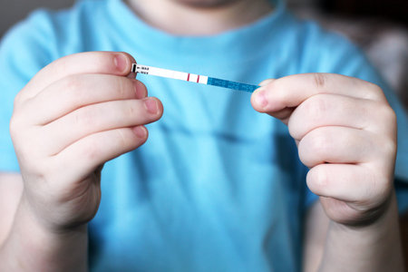 Pregnancy test in in children's hands, healthの写真素材