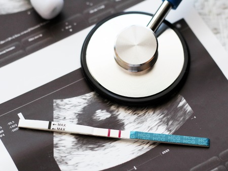 The fetus of a pregnant woman and pregnancy test, healthの写真素材