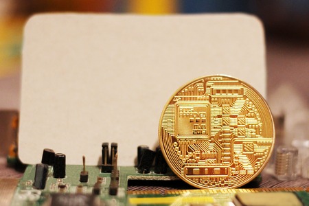 Golden Bitcoin virtual currency on a circuit board background, objectの写真素材