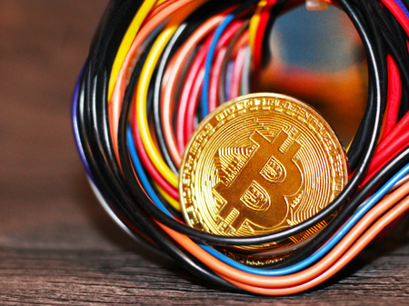 Golden Bitcoin virtual currency on a circuit board background, objectの写真素材