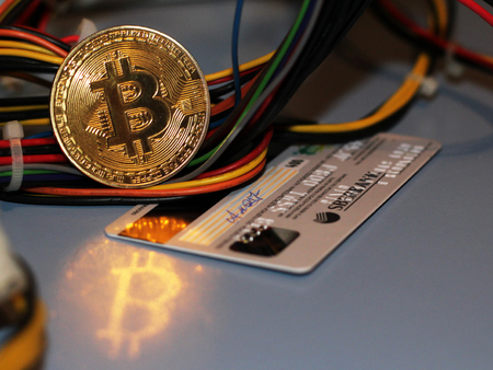 Golden Bitcoin virtual currency on a circuit board background, objectの写真素材