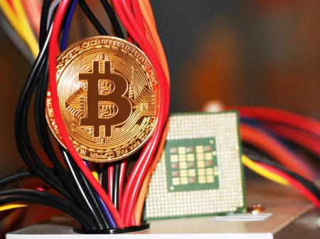 Golden Bitcoin virtual currency on a circuit board background, object