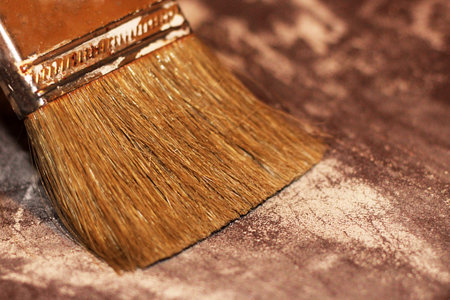 On the old wooden table is a brush. Painting a wooden surface. To mold a tree.