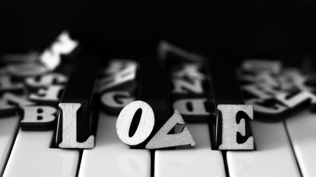 Piano keys closeup with the letters love and the heart. The idea of the concept for composer, concert, musical inspiration, love of music. The original art image with valentine.の写真素材