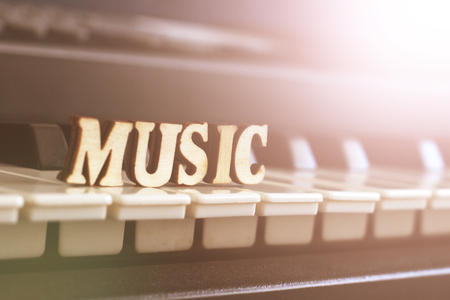 Piano keys closeup with the letters music , objectの写真素材