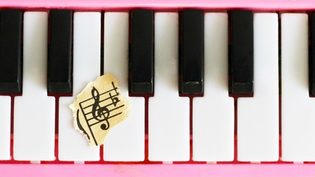 close-up music score on piano keyboard, piece of paper, objectの写真素材