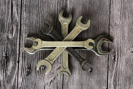 Tools for repairs on a wooden background, metal