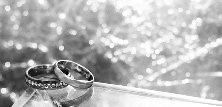 Wedding rings and water. grey background, goldenの写真素材