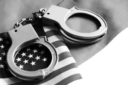Usa legal system concept, handcuffs on money background and american flagの写真素材