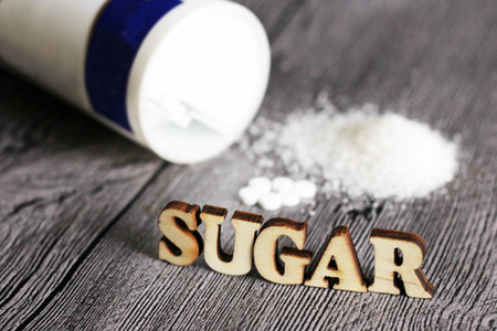 Sweetener tablet and sugar. Text sugar wooden letters. Food.の写真素材