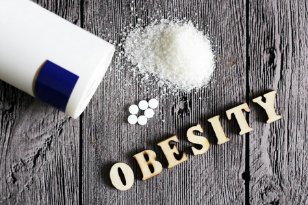 weetener tablet and sugar. Text obesity wooden letters. Food.の写真素材