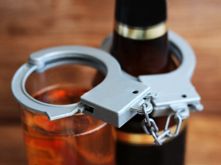 Bottle beer and handcuffs, the concept of sobriety and drunkenness, objectの写真素材