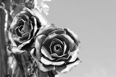 Two metal roses on a background of blue sky, artの写真素材