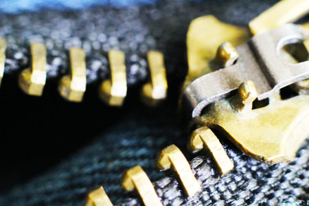 black zipper and lock on jeans background, so close