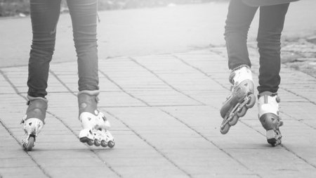 Two girls play sports in the Park, roller skating, black and white