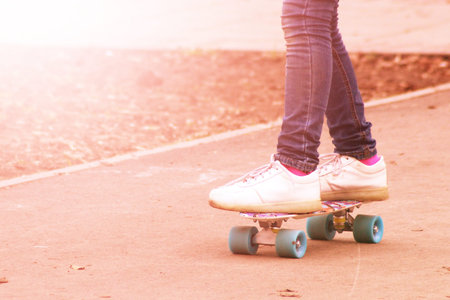 Close up of a skateboarders feet while skating active performance of stunt teenager shot in the air...