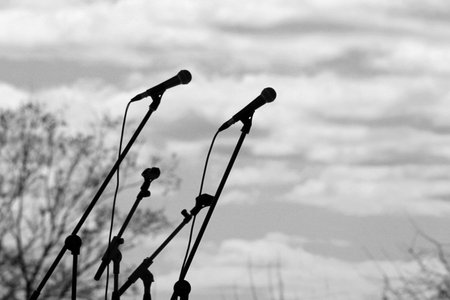 Many microphones on a stand over the sky, outdoorの写真素材