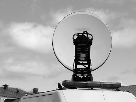 Satellite dish antennas with sky, police car, outdoorの写真素材