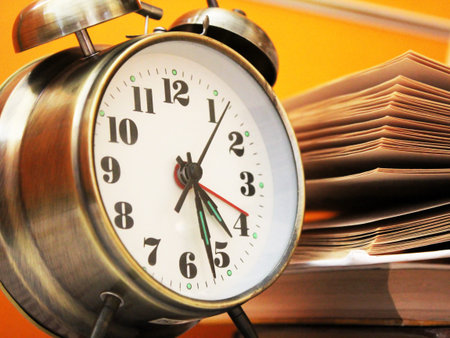 Retro alarm clock and books so close