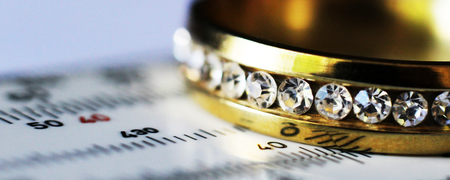 Gold ring with diamonds and a measuring instrument, the value of jewelry, objectの写真素材