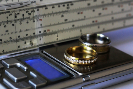 Gold ring with diamonds and a measuring instrument, the value of jewelry, objectの写真素材