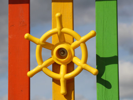 Playground equipment - Yellow steering wheel on red bars