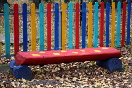 Red bench for children in the Park, outdoorsの写真素材