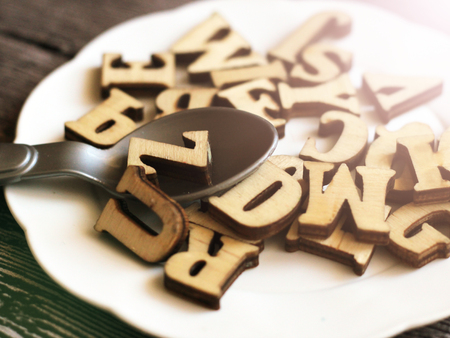 The word diet on a plate, wooden letters, tonedの写真素材