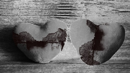 two broken hearts concept, wooden background, black and whiteの写真素材