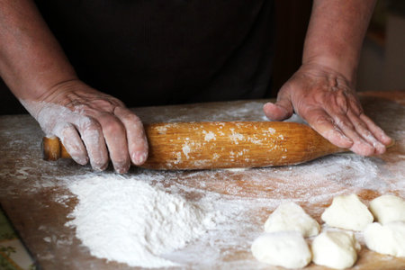 Female hands making dough for pizza, food