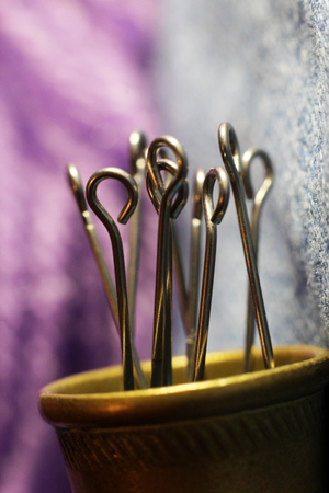 The pin of the thimble on a purple background, macroの写真素材