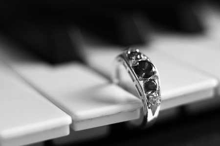Beautiful valuable ring with stones on the piano so closeの写真素材
