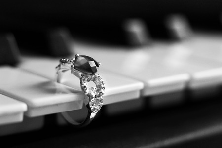 Beautiful valuable ring with stones on the piano so closeの写真素材