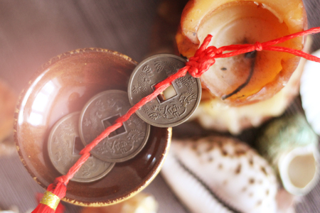 Three Chinese coins, shells and candles, top viewの写真素材